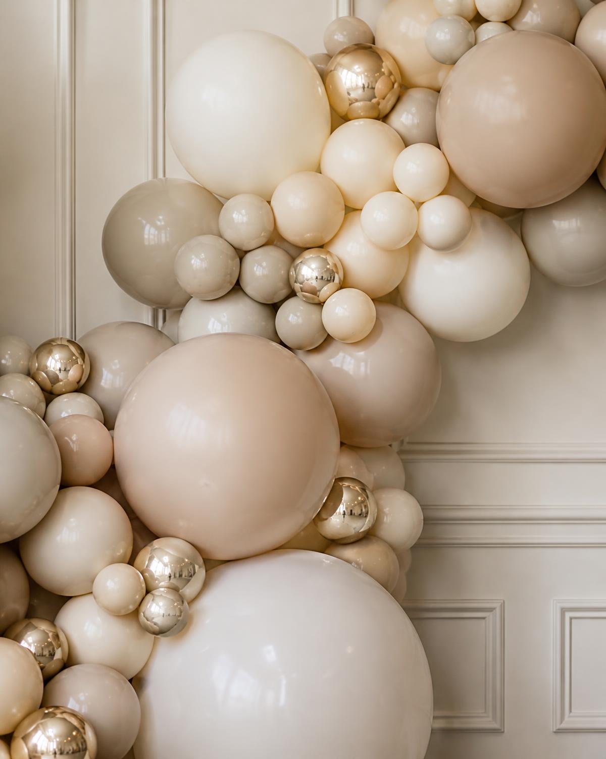 Custom balloon garland and backdrop installation at an Atlanta event